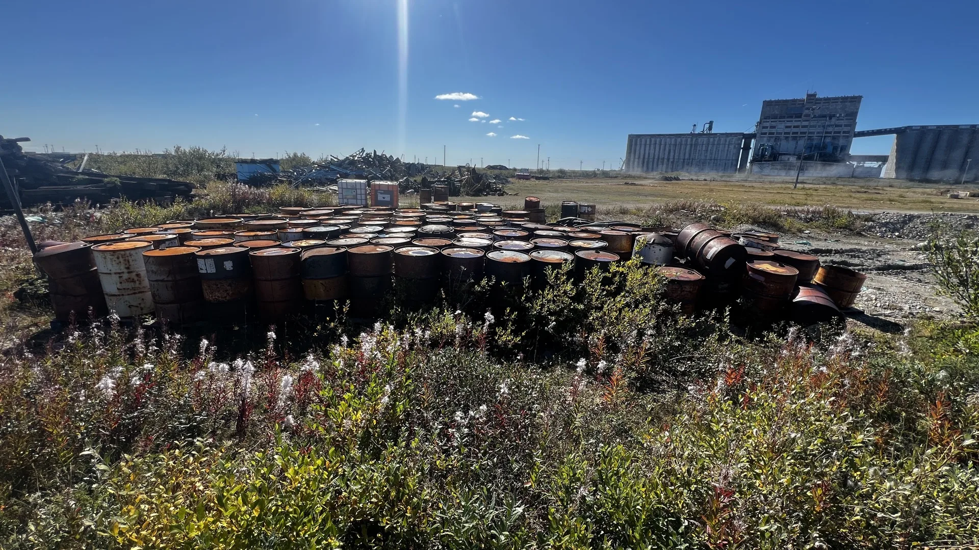 Rusted oil drums at a legacy contamination site requiring remediation